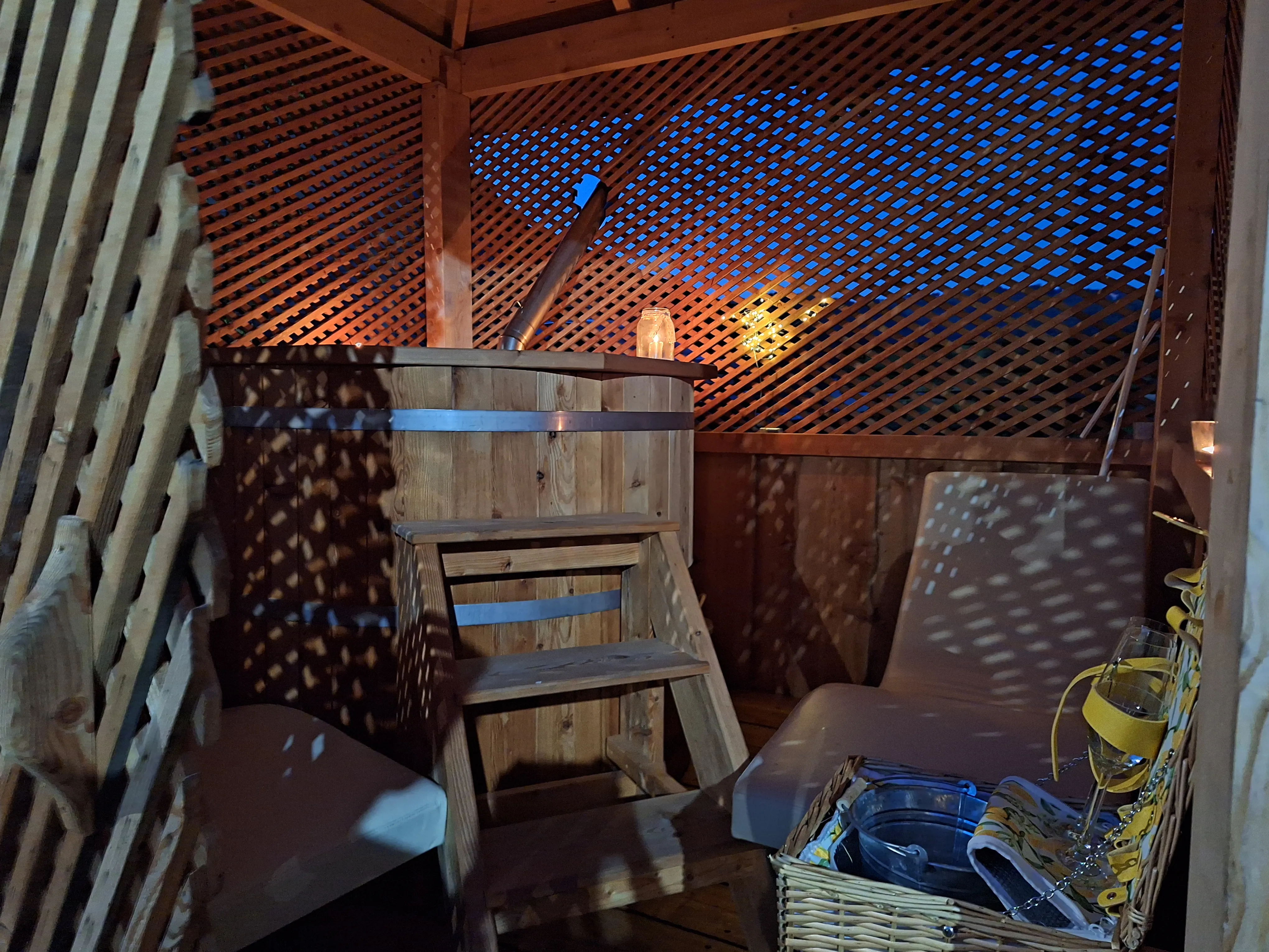 Wood-fired hot tub at dusk.